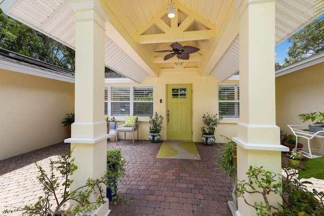 view of exterior entry with ceiling fan