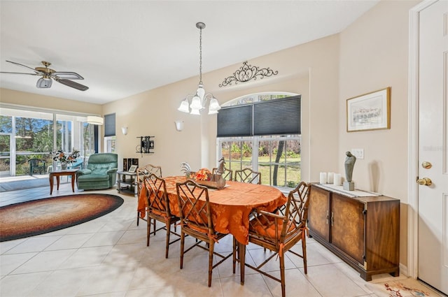 dining room featuring ceiling fan with notable chandelier and light tile patterned flooring