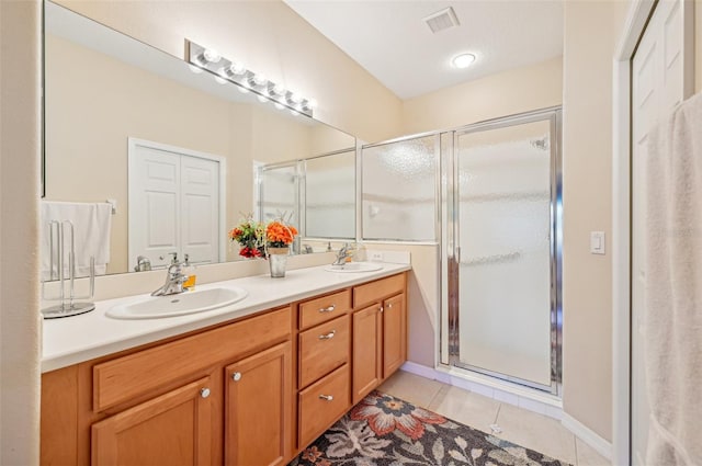 bathroom with vanity, tile patterned flooring, and an enclosed shower