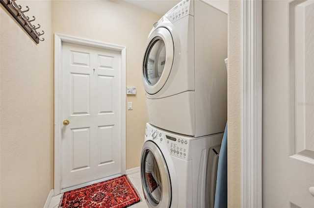 laundry area featuring stacked washer / drying machine