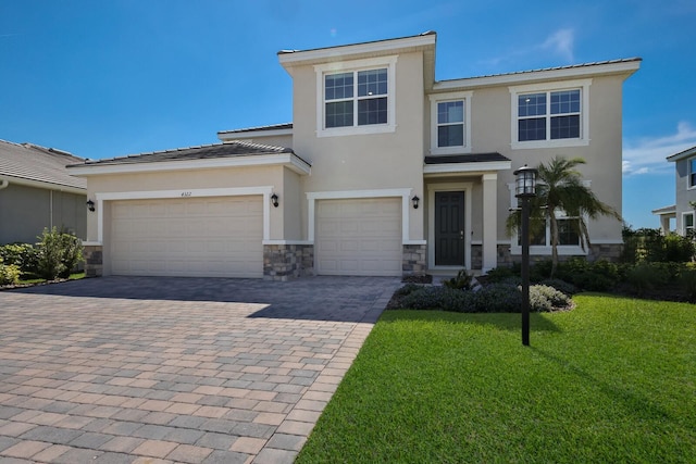 view of front of house featuring a front yard and a garage