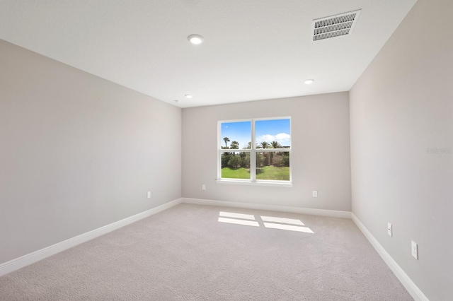 unfurnished room with light carpet