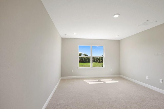 spare room featuring light colored carpet