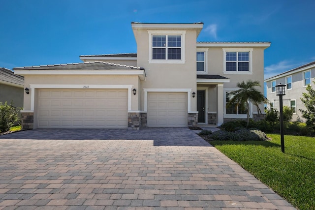 4322 Silo Port Ct, Lakewood Ranch, FL 34211 - view of front of house featuring decorative driveway, stone siding, stucco siding, and a front lawn