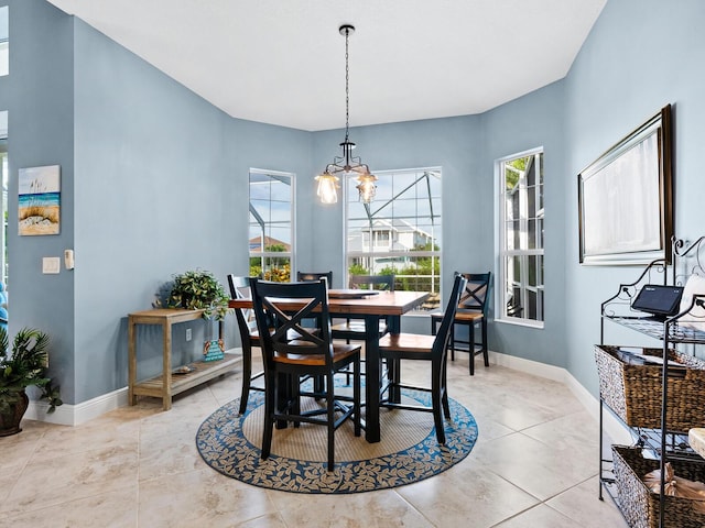 tiled dining space with an inviting chandelier