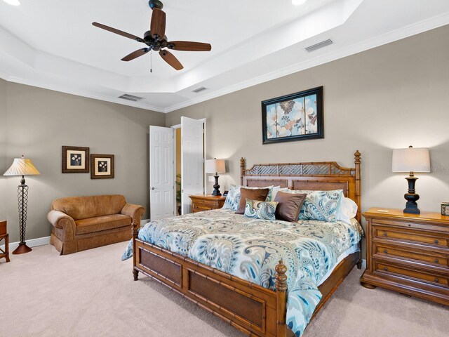 bedroom featuring crown molding, light carpet, ceiling fan, and a raised ceiling