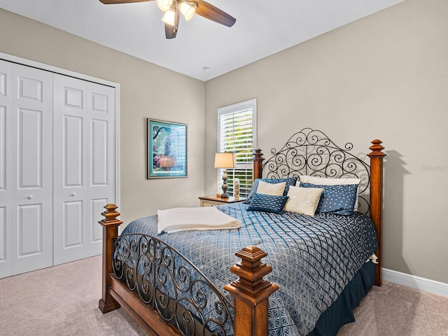 carpeted bedroom with a closet and ceiling fan