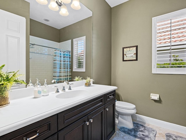 bathroom with toilet, a shower with curtain, vanity, and plenty of natural light