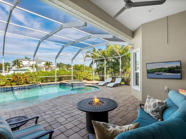 view of swimming pool with a patio, a lanai, ceiling fan, and an in ground hot tub