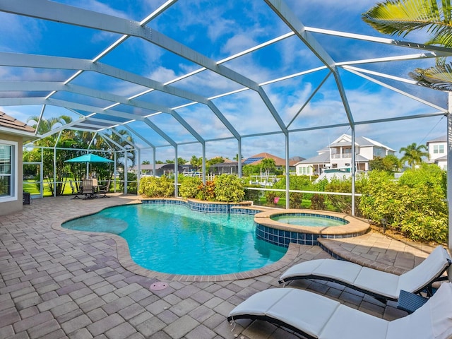 view of pool featuring a patio, a lanai, and an in ground hot tub