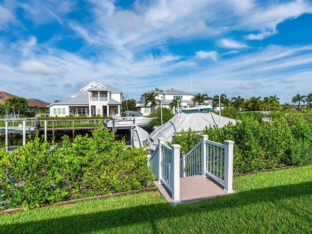 exterior space featuring a lawn and a boat dock