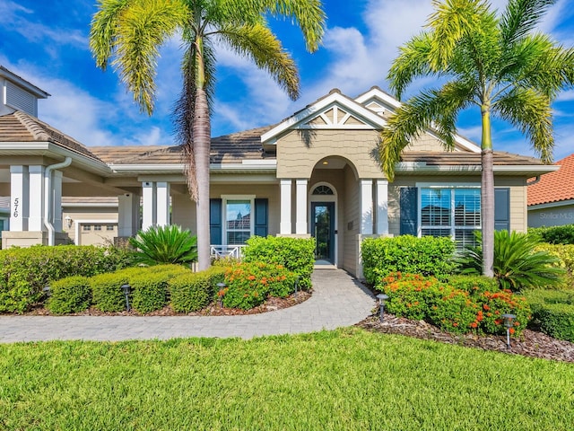 view of front of house with a garage and a front yard