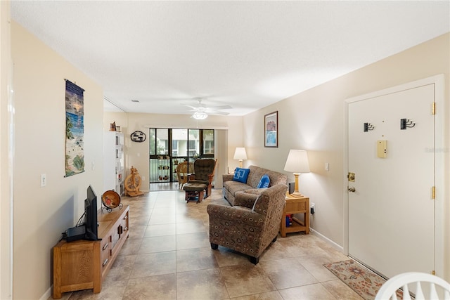 living room featuring light tile patterned floors and ceiling fan