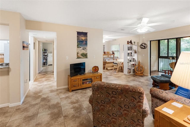 living room with tile patterned flooring and ceiling fan