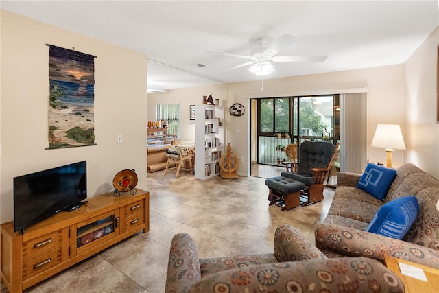 living room featuring ceiling fan and light tile patterned floors