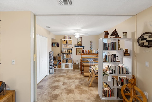 office space with ceiling fan and a textured ceiling