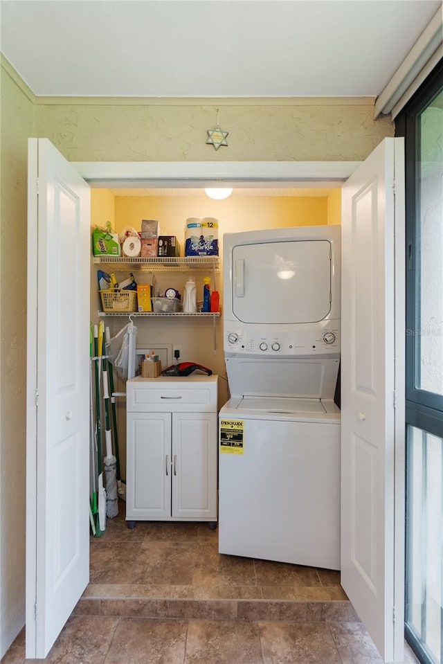 washroom featuring stacked washer and dryer