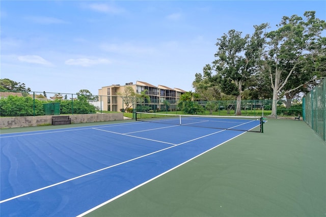 view of tennis court with basketball hoop