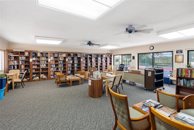 interior space with ceiling fan