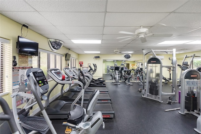 gym featuring a paneled ceiling and ceiling fan