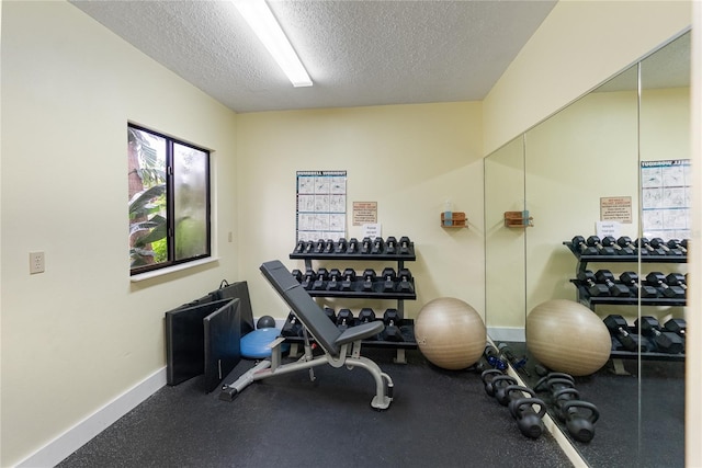 exercise area featuring a textured ceiling