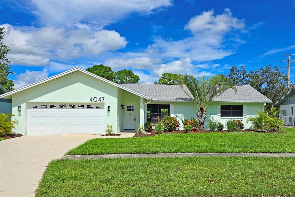 ranch-style home featuring a garage and a front lawn