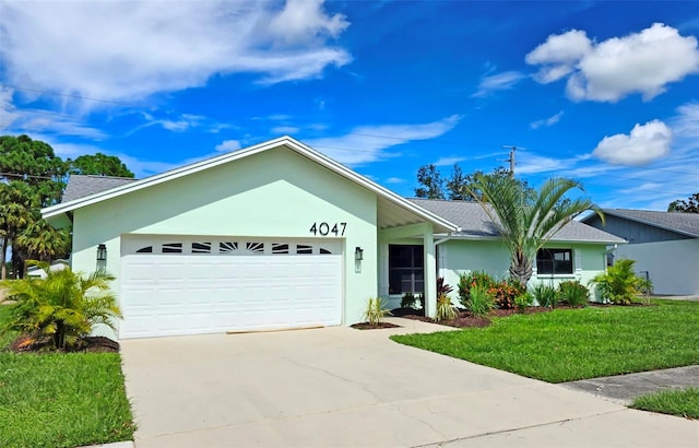 single story home featuring a garage and a front yard