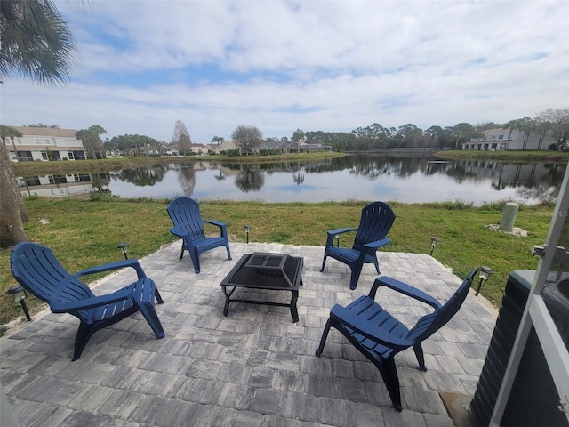 view of patio featuring a water view and an outdoor fire pit