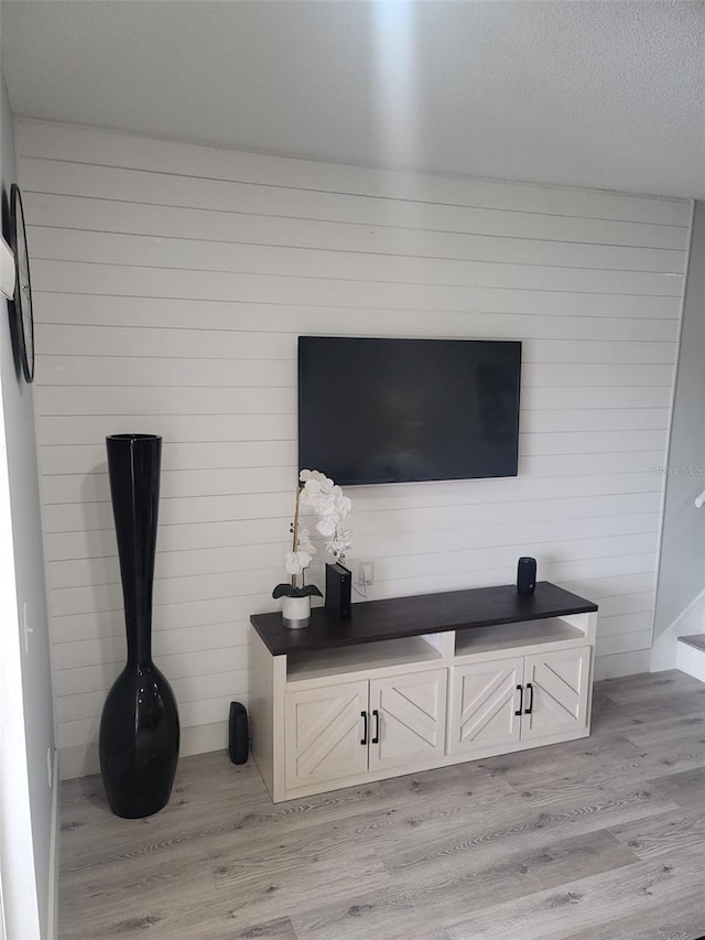 details with a textured ceiling and wood finished floors