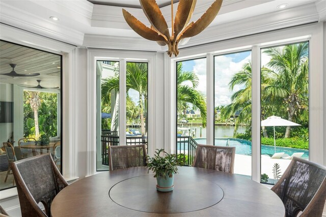 interior space featuring ceiling fan, crown molding, and a water view