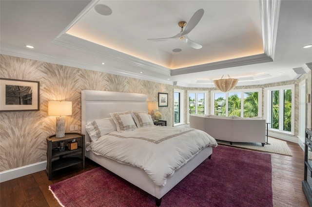 bedroom with wood-type flooring, a raised ceiling, ornamental molding, and ceiling fan