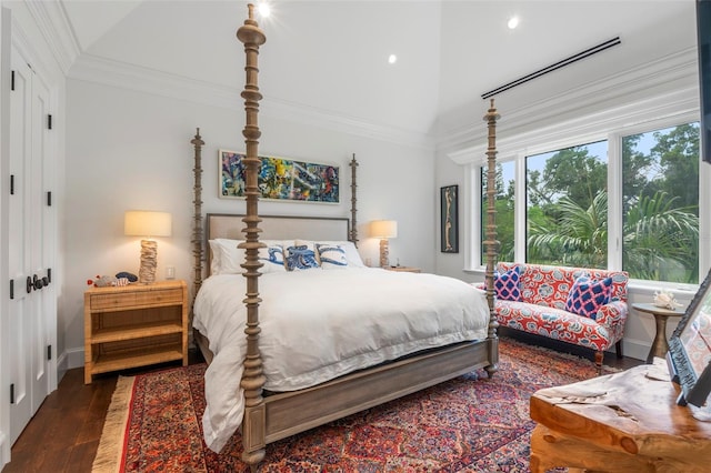 bedroom featuring ornamental molding, lofted ceiling, and dark wood-type flooring