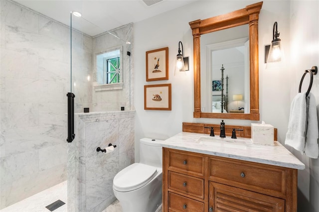 bathroom featuring tiled shower, vanity, and toilet