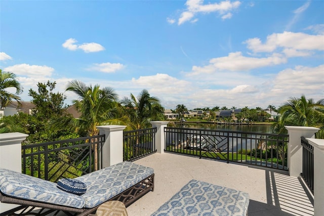 view of patio with a water view and a balcony