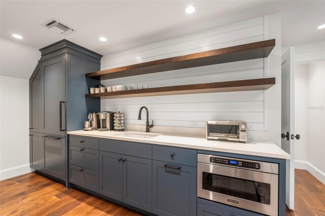 501 Harbor Point Rd, Longboat Key, FL 34228 - bar with a sink, wood finished floors, baseboards, recessed lighting, and stainless steel microwave