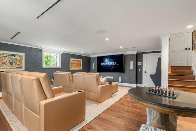 cinema room featuring light hardwood / wood-style floors and crown molding