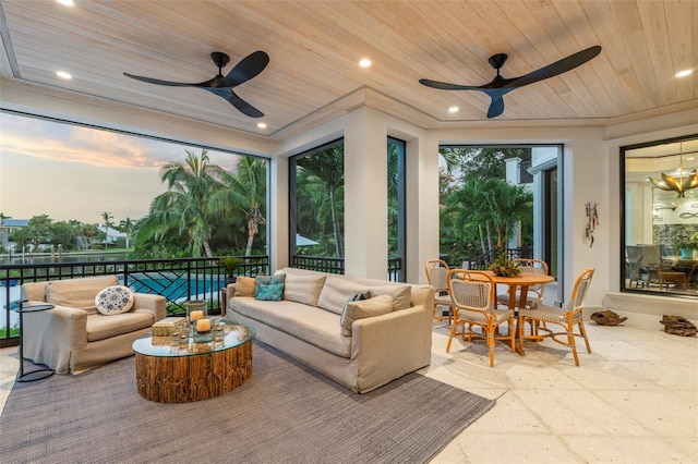 sunroom with ceiling fan and wood ceiling