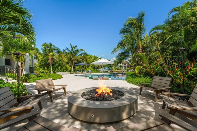 501 Harbor Point Rd, Longboat Key, FL 34228 - view of patio with an outdoor fire pit and an outdoor pool