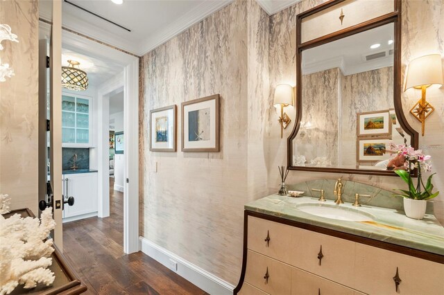 501 Harbor Point Rd, Longboat Key, FL 34228 - bathroom featuring wood finished floors, vanity, crown molding, and baseboards
