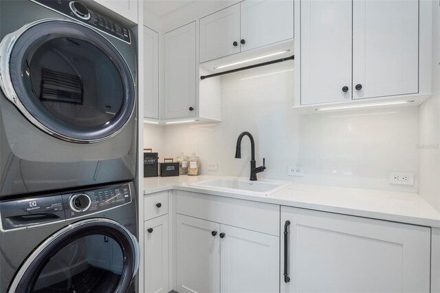 501 Harbor Point Rd, Longboat Key, FL 34228 - laundry area with stacked washing machine and dryer and cabinet space