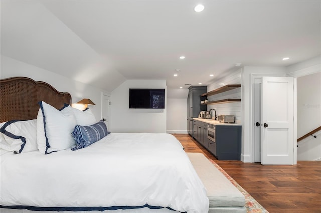 bedroom featuring vaulted ceiling, dark hardwood / wood-style floors, and sink