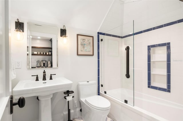 bathroom featuring shower / bath combination with glass door and toilet