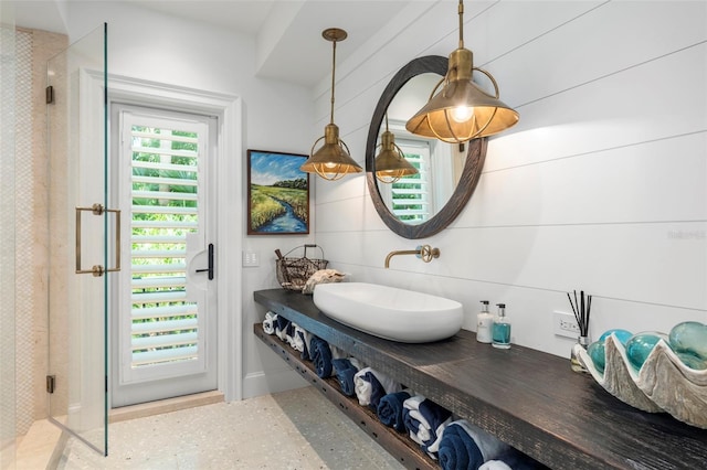 bathroom featuring walk in shower and vanity