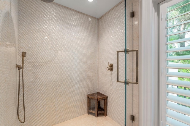 bathroom with a shower with door