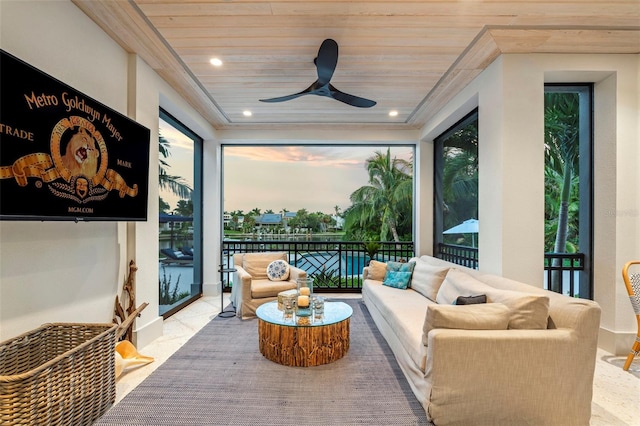 sunroom featuring ceiling fan and wooden ceiling