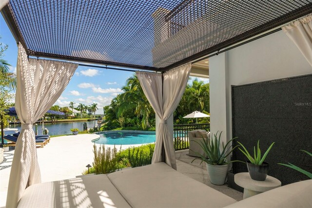501 Harbor Point Rd, Longboat Key, FL 34228 - outdoor pool featuring a water view and a patio