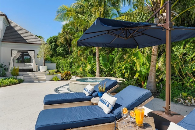 view of patio / terrace featuring an outdoor hot tub