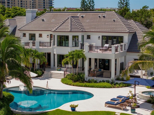 501 Harbor Point Rd, Longboat Key, FL 34228 - back of house featuring a balcony, a patio area, and a tile roof