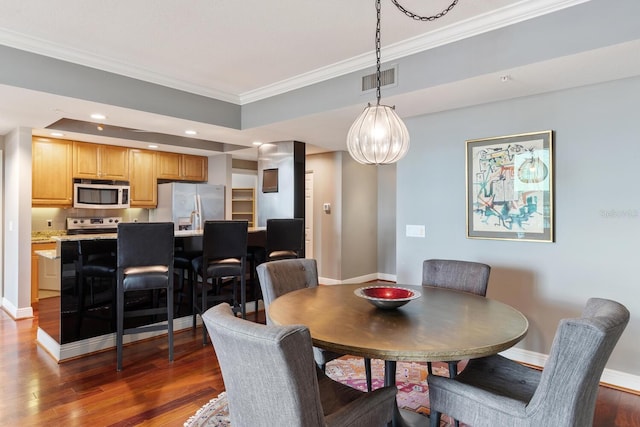 dining room with crown molding and dark wood-type flooring