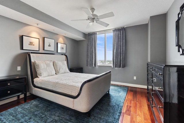 bedroom with ceiling fan and dark hardwood / wood-style flooring